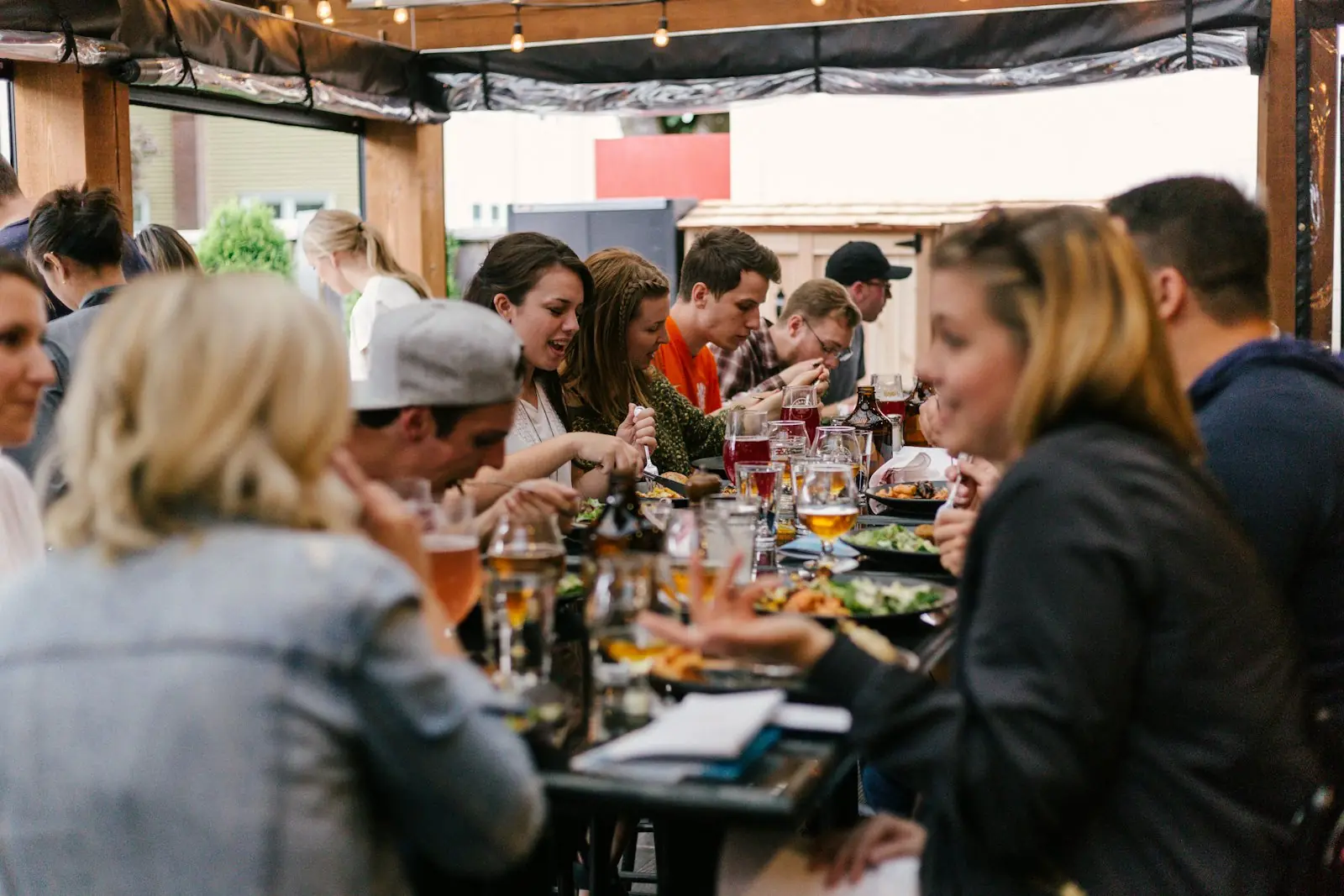 A long table of people sharing food and conversation